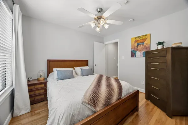 a bedroom with a bed and wooden floor