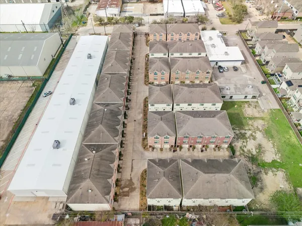 an aerial view of residential houses with outdoor space