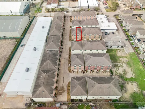 an aerial view of residential houses with outdoor space