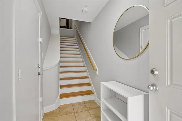 a view of entryway and hall with wooden floor