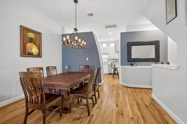 a view of a dining room with furniture and wooden floor