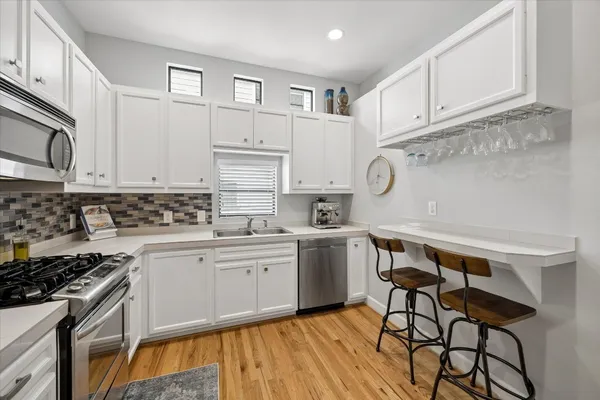 a kitchen with cabinets appliances and a counter space