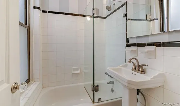 a bathroom with a sink a shower and a mirror