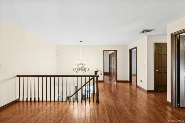 a view of hallway with wooden floor