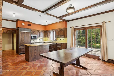 a kitchen with a table chairs refrigerator and cabinets