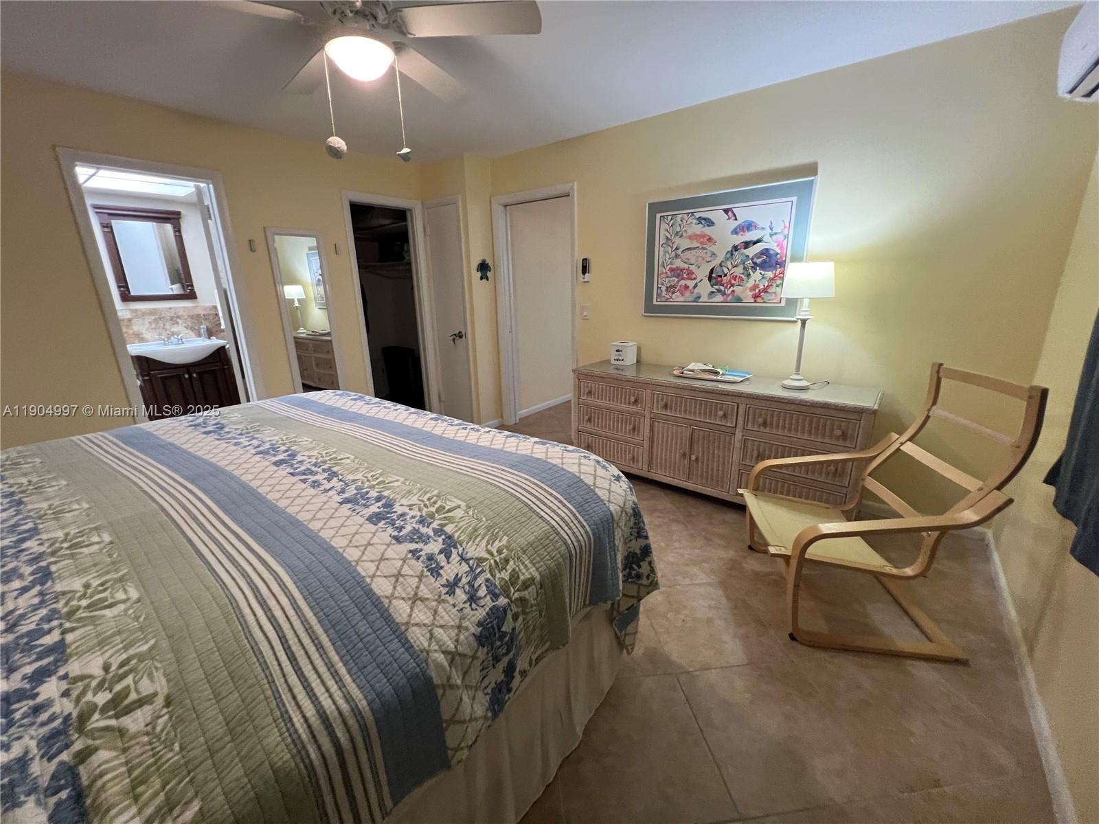 108 Bravado Lane, Unit 8 Palm Beach Shores, FL 33404 - Photo 11 of 17 a bedroom with two beds and a chandelier
