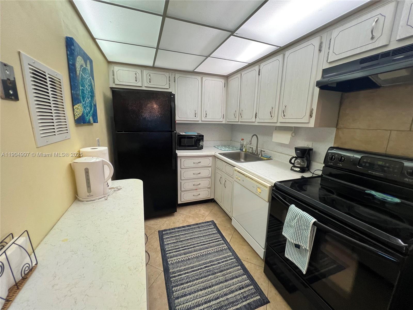 108 Bravado Lane, Unit 8 Palm Beach Shores, FL 33404 - Photo 13 of 17 a kitchen that has a sink and a stove