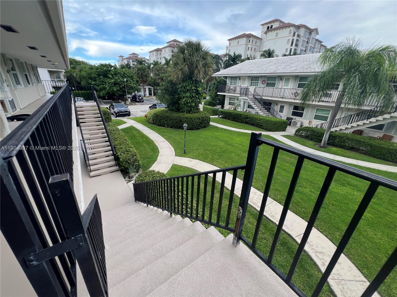108 Bravado Lane, Unit 8 Palm Beach Shores, FL 33404 - Photo 17 of 17 a view of a roof deck with couches chairs and wooden floor
