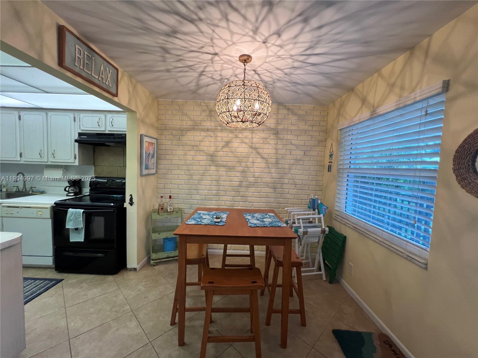 108 Bravado Lane, Unit 8 Palm Beach Shores, FL 33404 - Photo 3 of 17 a kitchen with a table and chairs in it