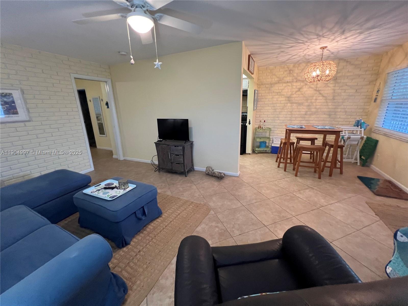 108 Bravado Lane, Unit 8 Palm Beach Shores, FL 33404 - Photo 6 of 17 a living room with furniture and a flat screen tv