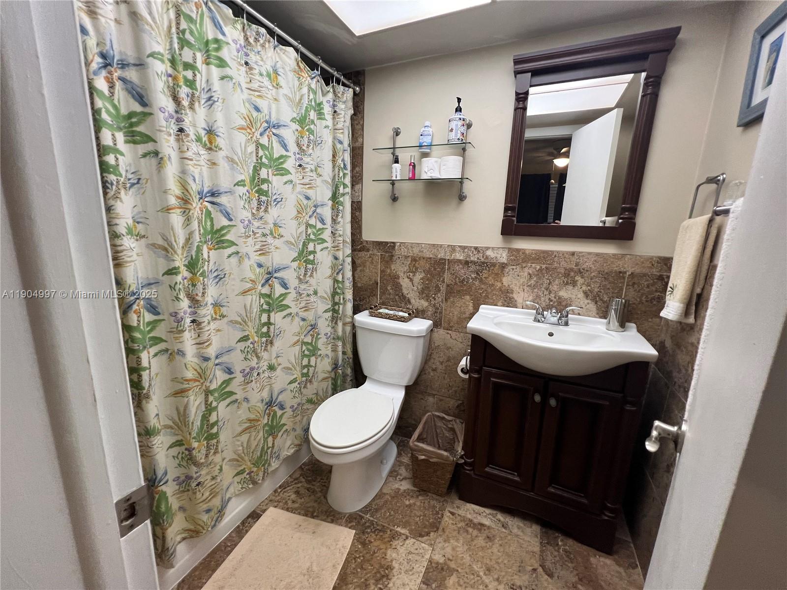 108 Bravado Lane, Unit 8 Palm Beach Shores, FL 33404 - Photo 7 of 17 a bathroom with a sink toilet and mirror
