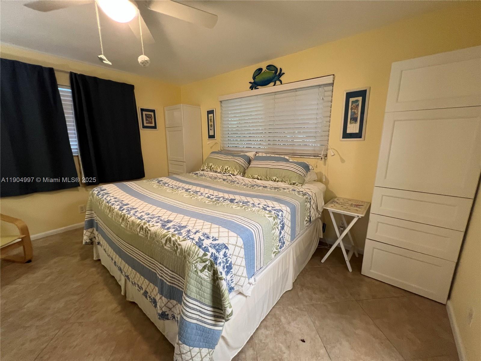 108 Bravado Lane, Unit 8 Palm Beach Shores, FL 33404 - Photo 8 of 17 a bedroom with a bed and a dresser