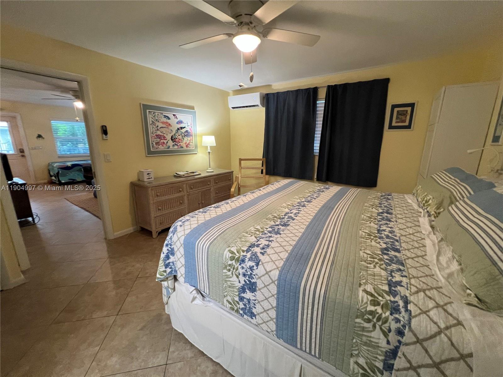 108 Bravado Lane, Unit 8 Palm Beach Shores, FL 33404 - Photo 9 of 17 a bedroom with a bed and a large mirror