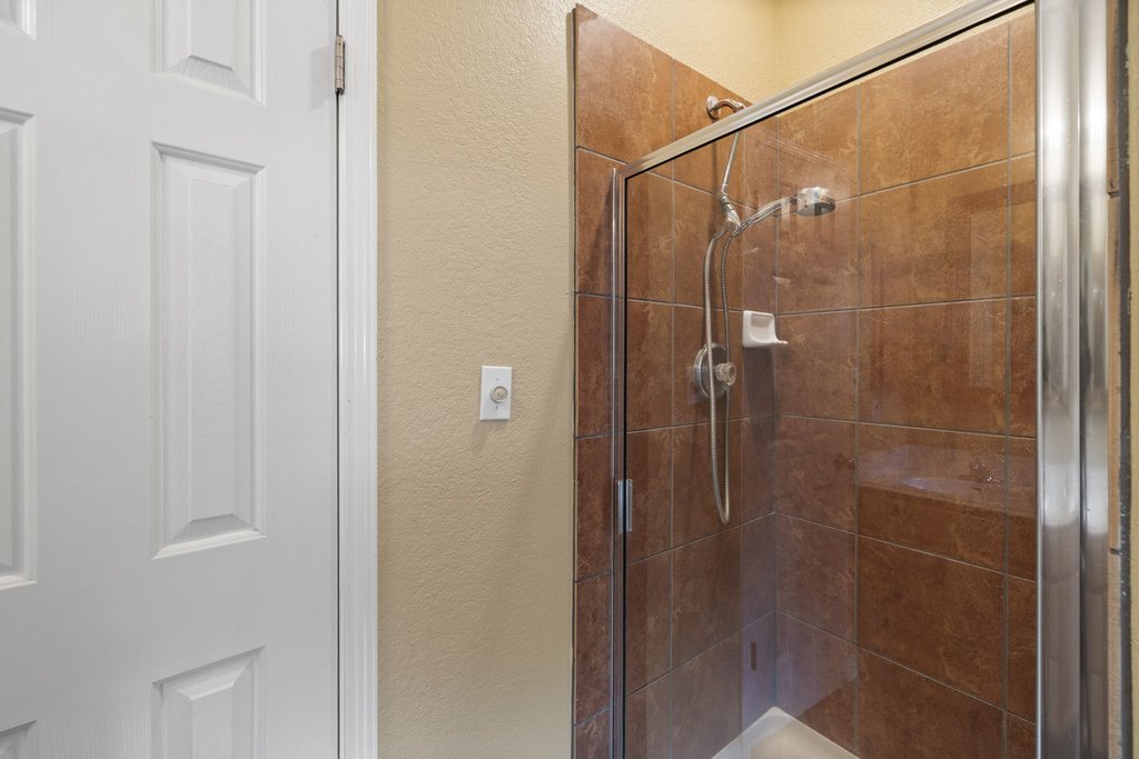 347 Spring Drive Kyle, TX 78640 - Photo 32 of 40 Step into a well-appointed shower with modern tile and a glass enclosure.