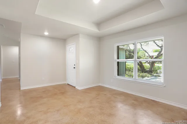 an empty room with windows and closet