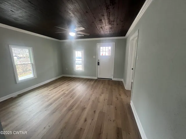 wooden floor in an empty room with a window