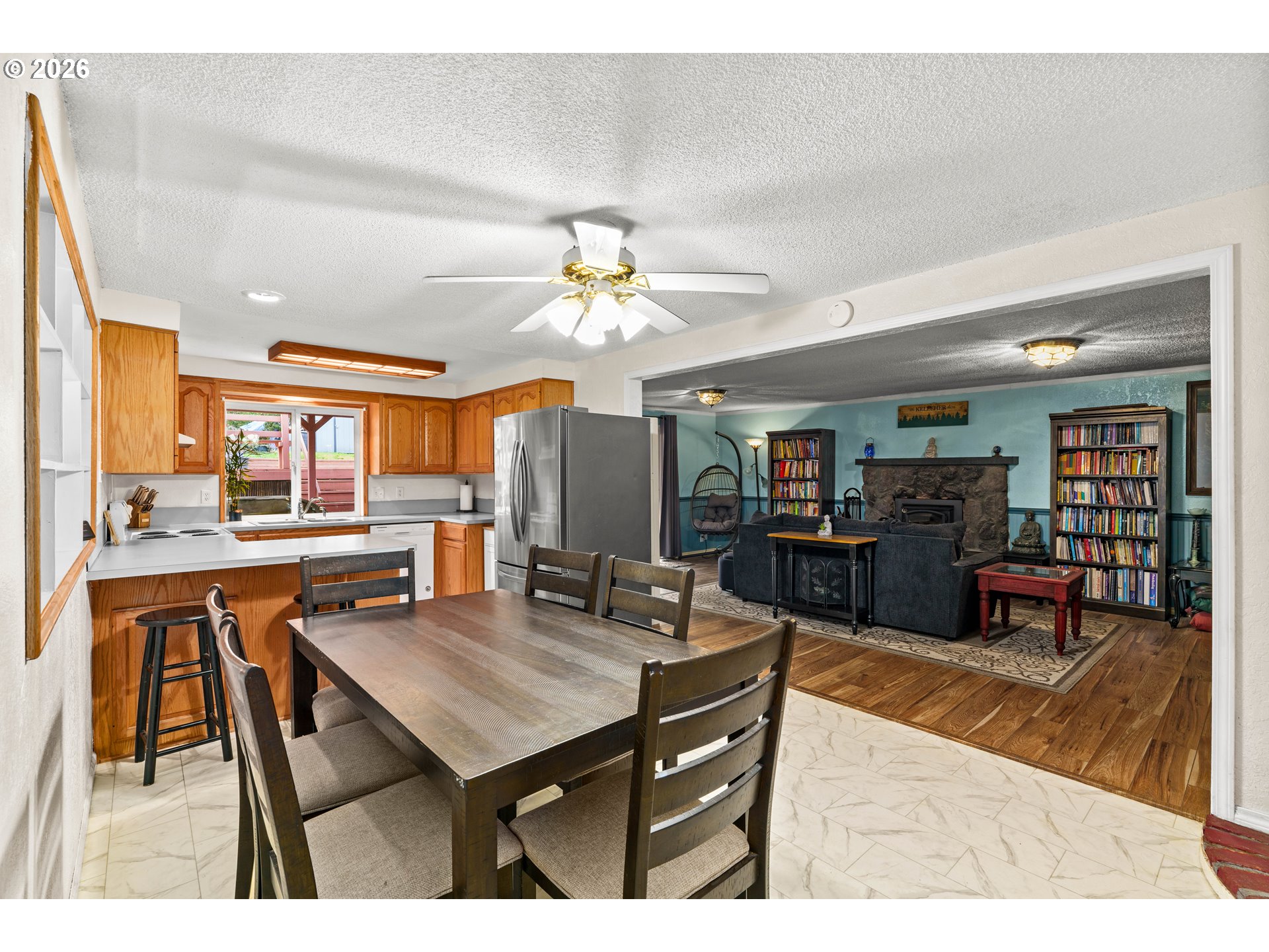 7027 South E Street Springfield, OR 97478 - Photo 11 of 39 a living room with furniture a table and chairs