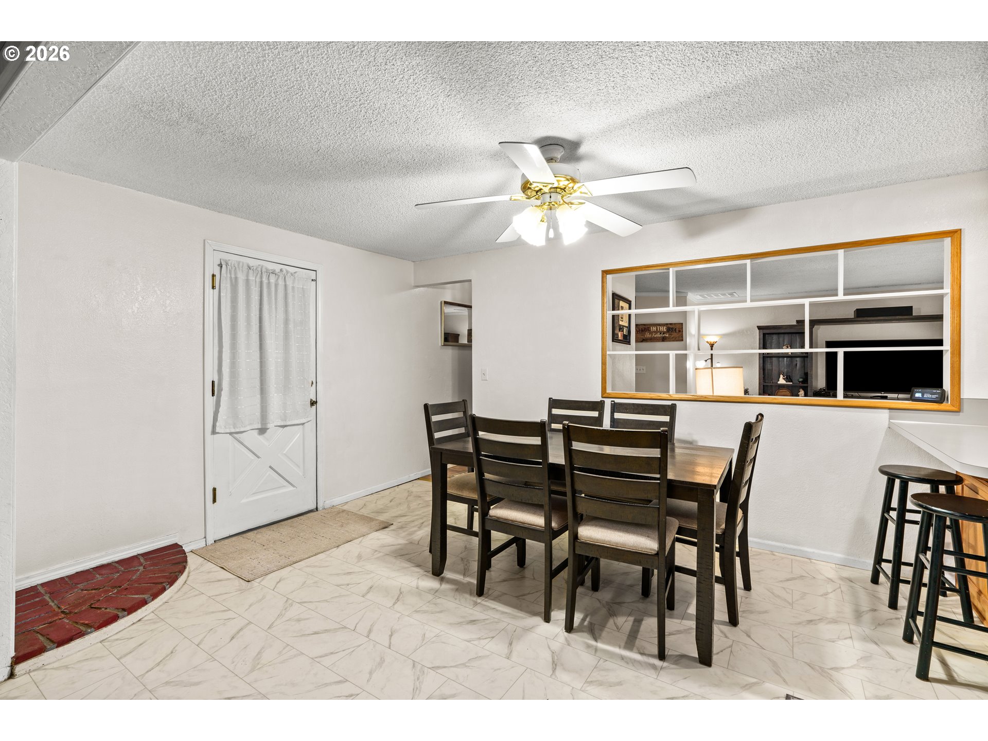 7027 South E Street Springfield, OR 97478 - Photo 12 of 39 a view of a dining room with furniture and wooden floor