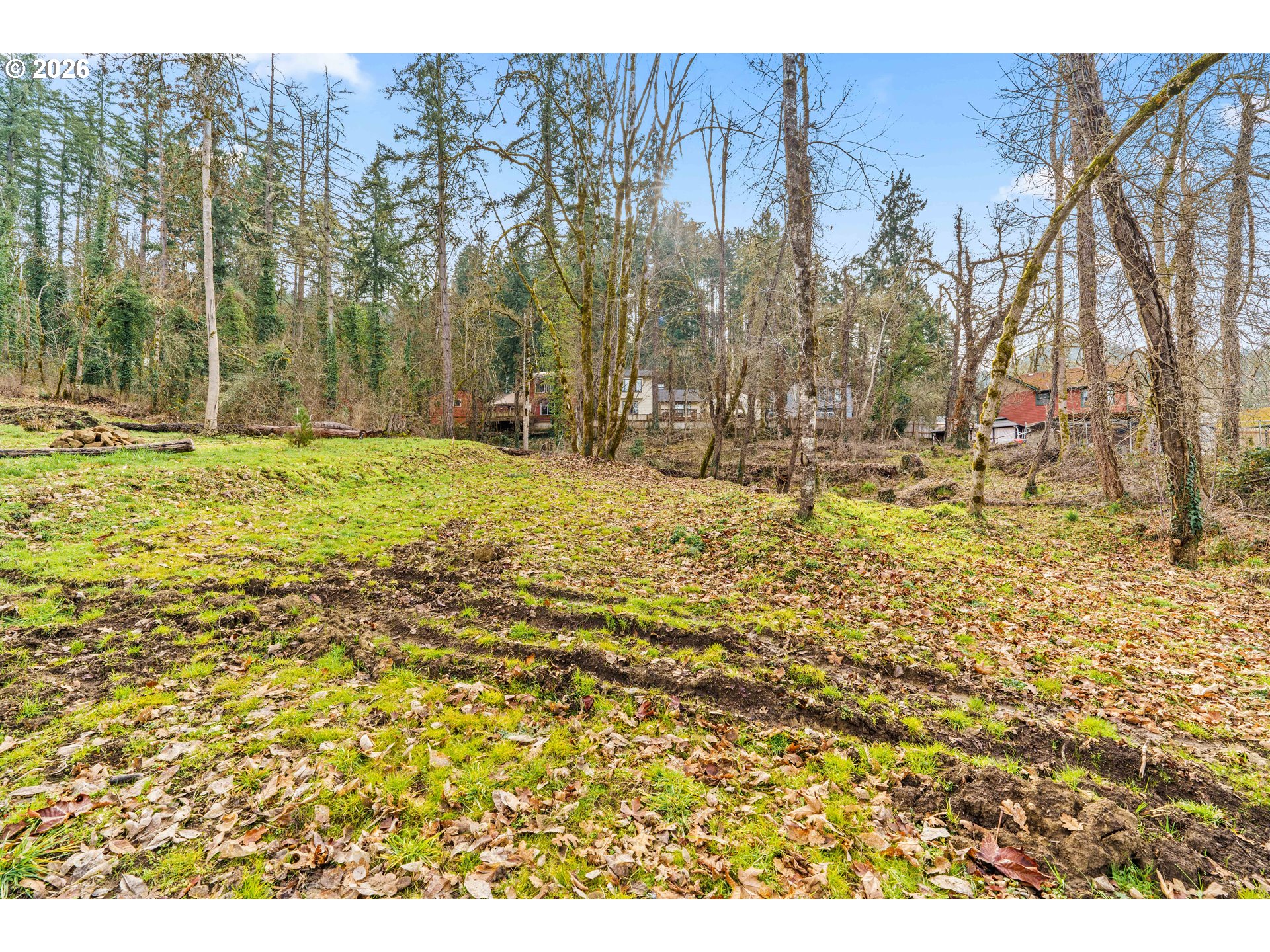7027 South E Street Springfield, OR 97478 - Photo 34 of 39 a backyard of a house with a fountain and large trees