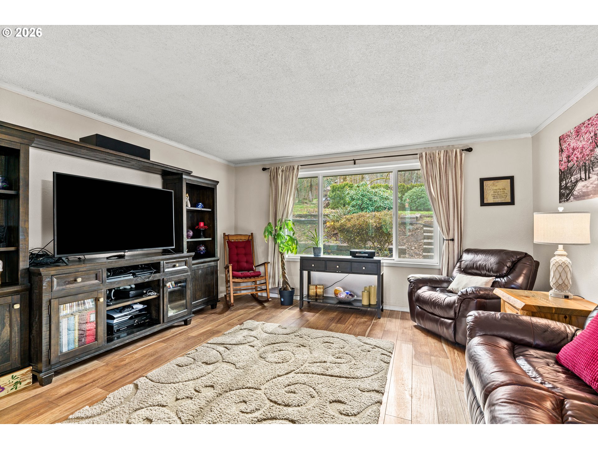7027 South E Street Springfield, OR 97478 - Photo 6 of 39 a living room with furniture and a flat screen tv