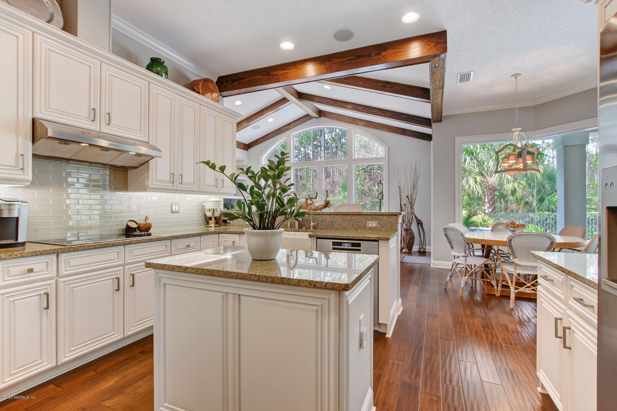 28 Lighthouse Point Circle Ponte Vedra, FL 32081 - Photo 22 of 108 a kitchen with stainless steel appliances granite countertop a stove a sink and white cabinets with wooden floor