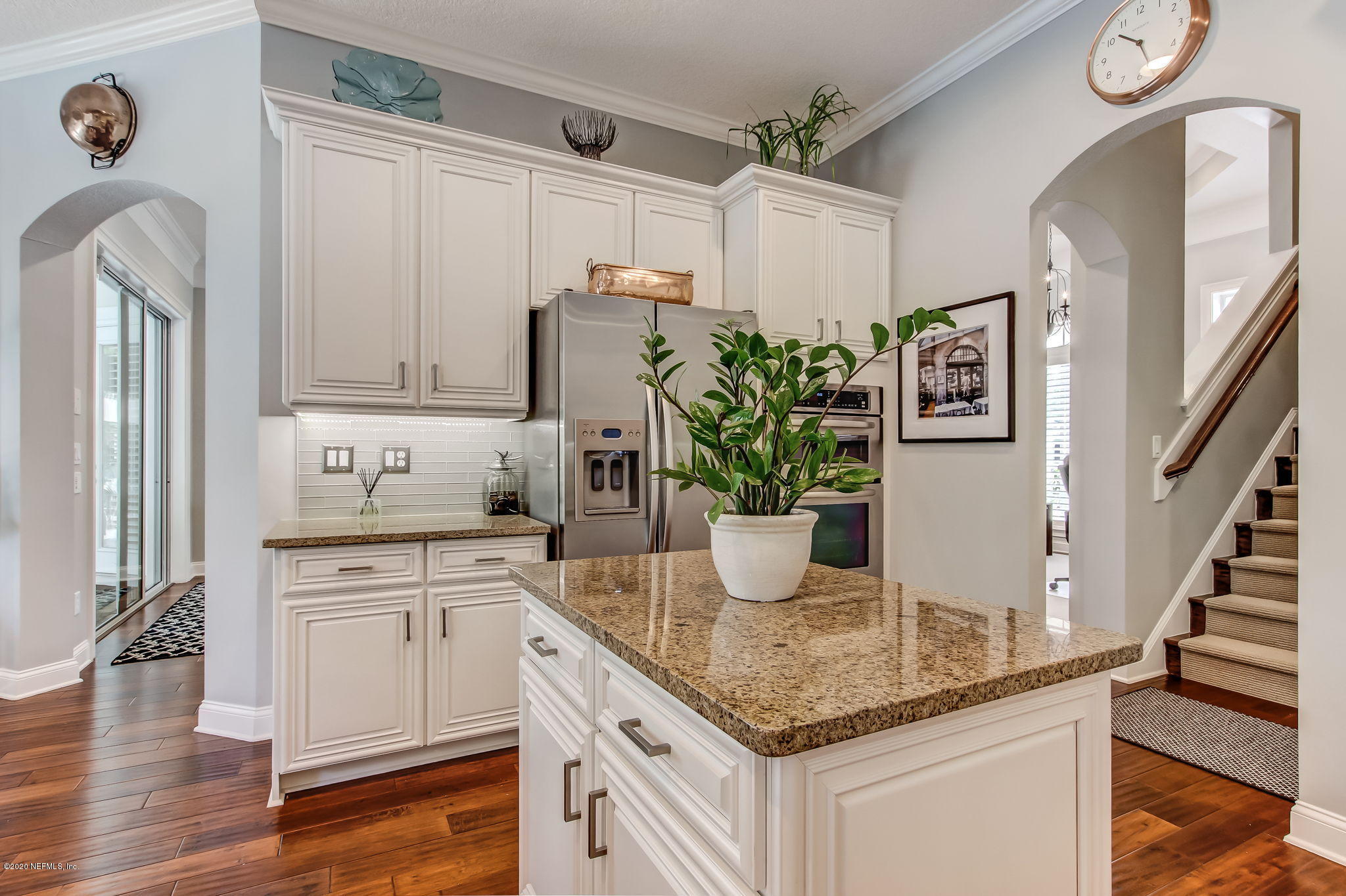 28 Lighthouse Point Circle Ponte Vedra, FL 32081 - Photo 24 of 108 a kitchen with stainless steel appliances kitchen island granite countertop a refrigerator a sink dishwasher and white cabinets with wooden floor