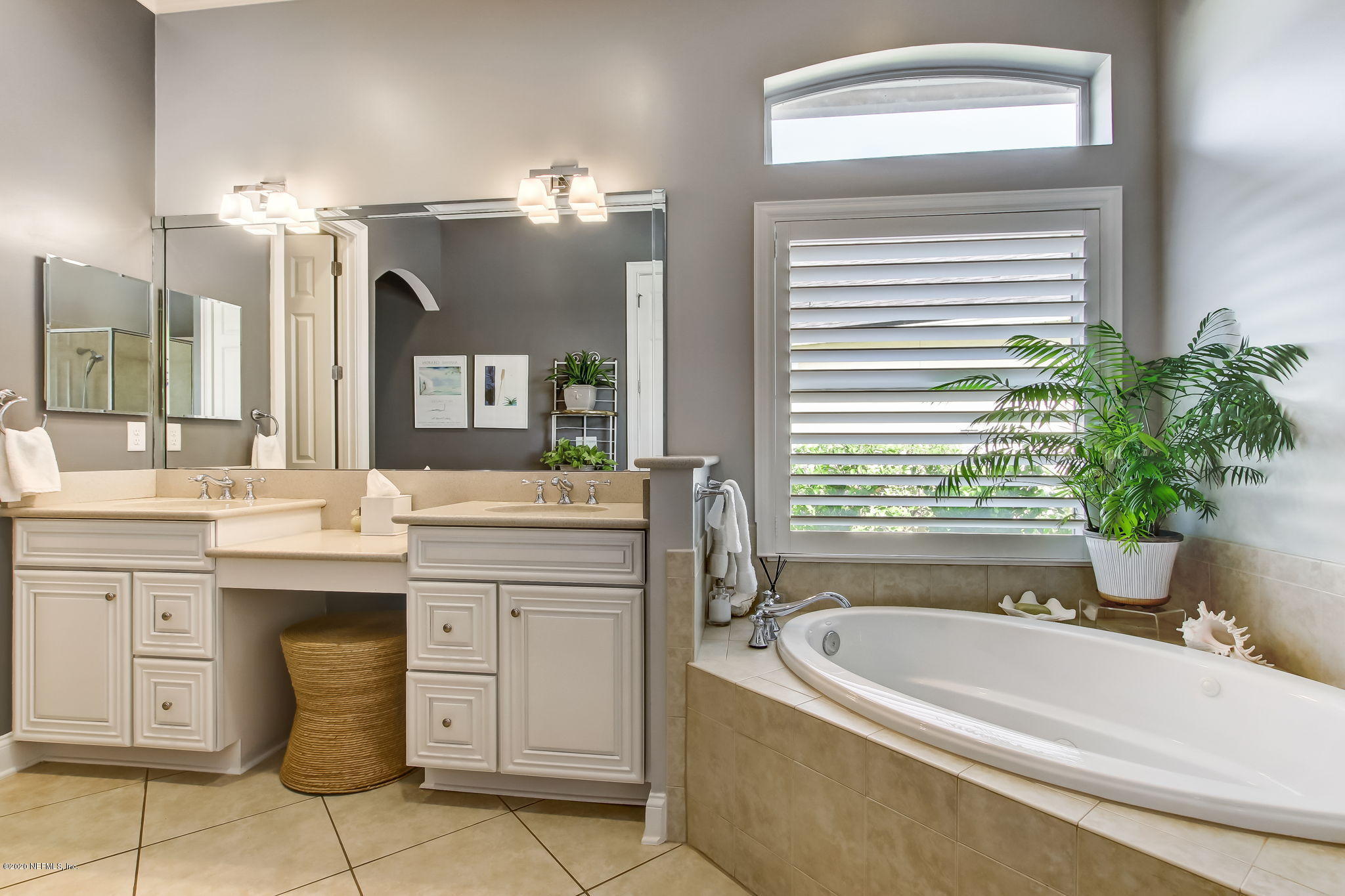 28 Lighthouse Point Circle Ponte Vedra, FL 32081 - Photo 34 of 108 a bathroom with a tub a double vanity sink and a large mirror