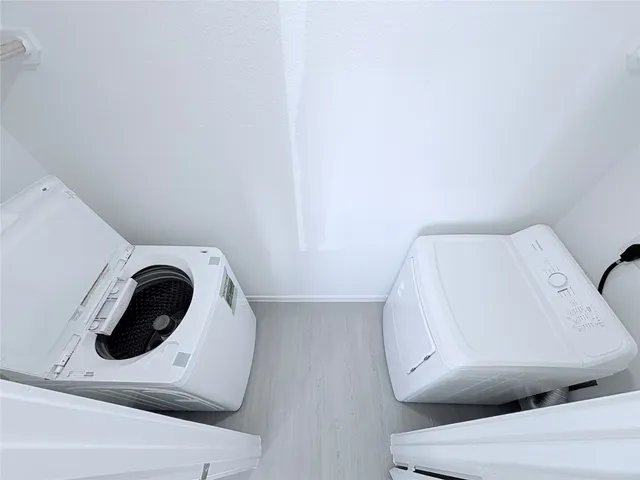a bathroom with a toilet and dryer