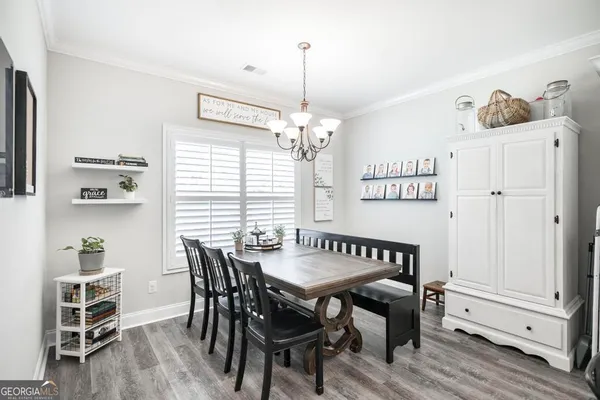 a kitchen with stainless steel appliances granite countertop white cabinets and a stove top oven with granite countertops