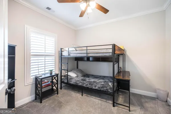 a view of a hallway with wooden floor and windows