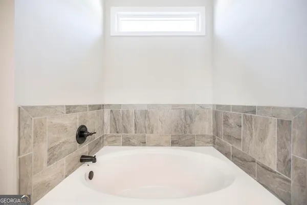 a bathroom with a bathtub and a window