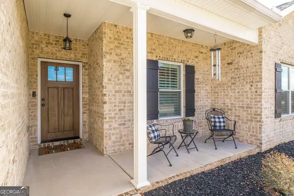 a view of a hallway with wooden floor and a livingroom
