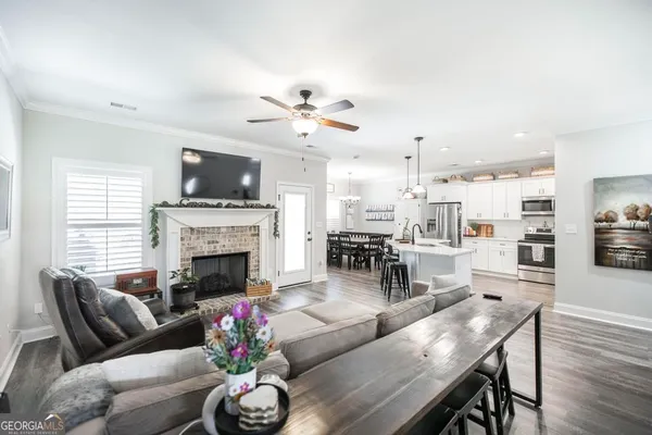 a living room with furniture fireplace and flat screen tv