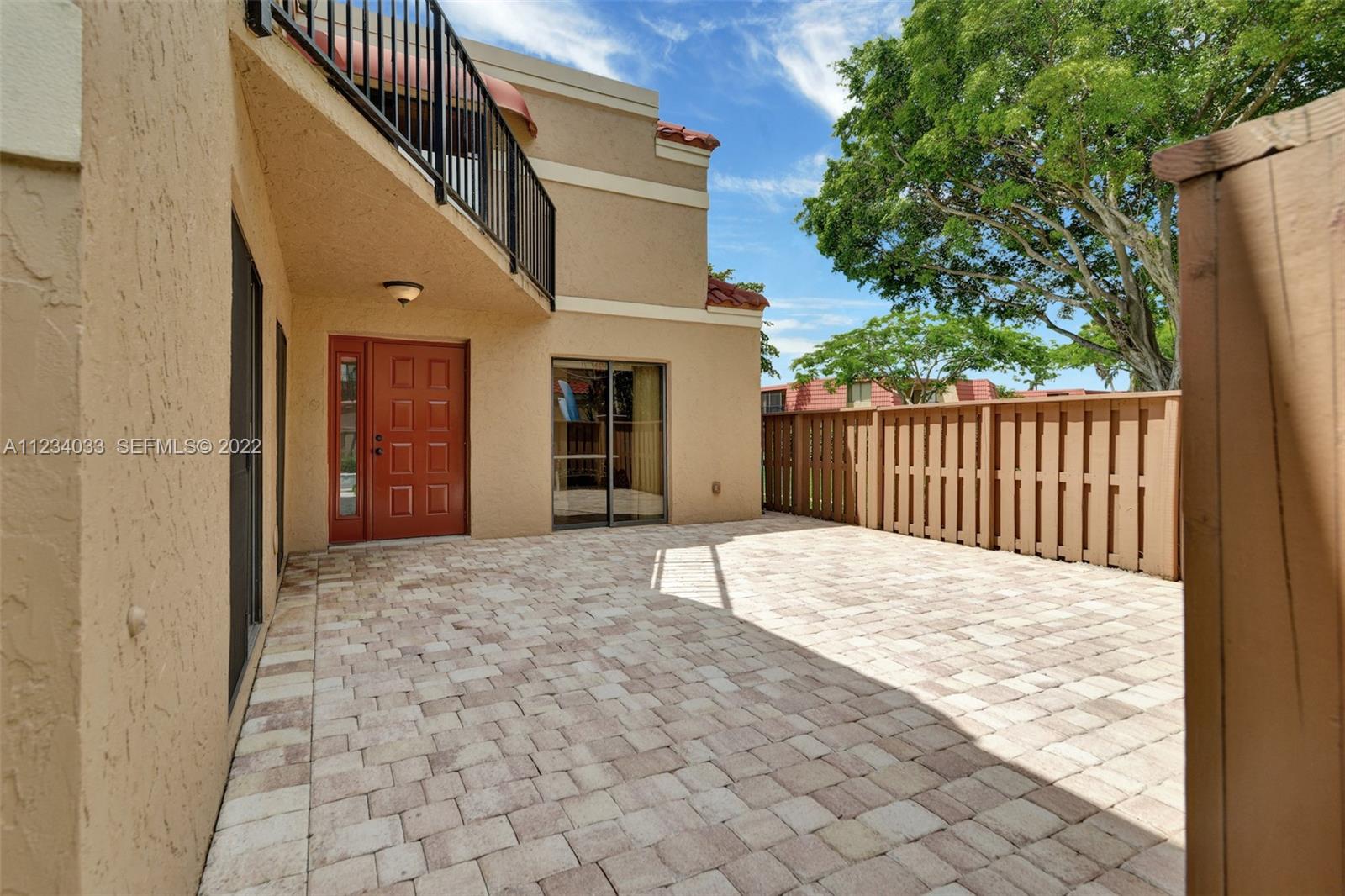 8171 Thames Boulevard, Unit A Boca Raton, FL 33433 - Photo 4 of 34 a view of a house with a wooden fence