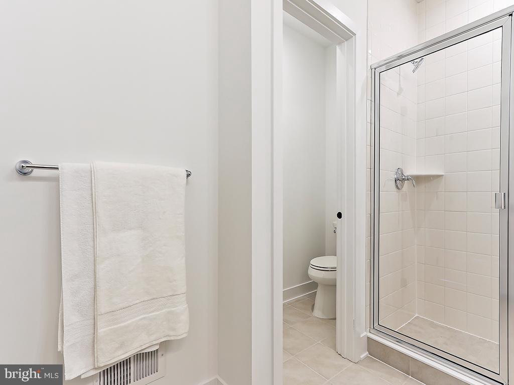 6105 Vivaldi Road Princeton, NJ 08540 - Photo 23 of 28 a bathroom with a granite countertop shower and a toilet