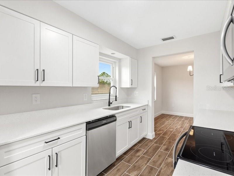 1941 Settlement Road, Unit 11 Venice, FL 34285 - Photo 12 of 39 a kitchen with a sink and cabinets