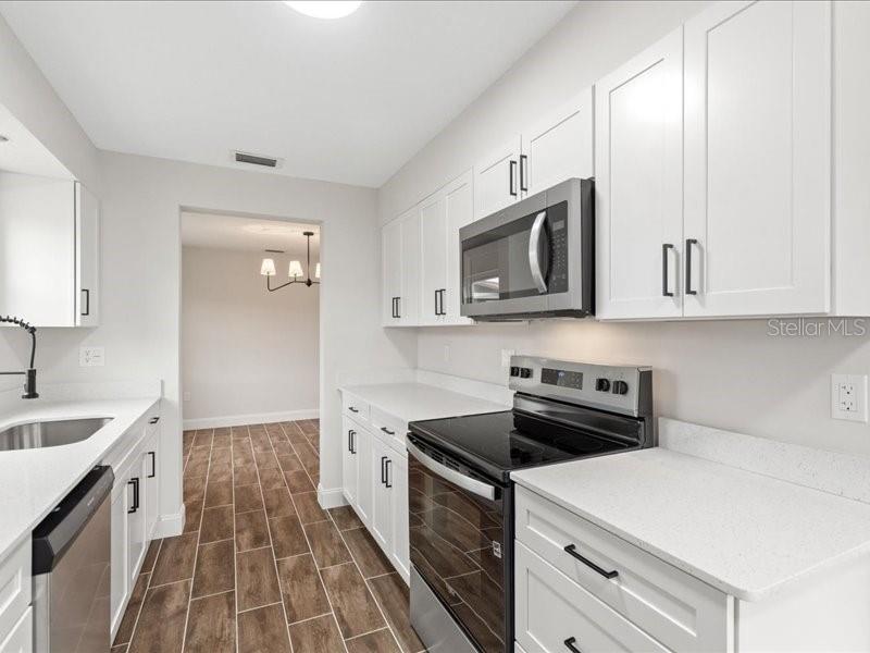 1941 Settlement Road, Unit 11 Venice, FL 34285 - Photo 13 of 39 a kitchen with a sink stove and microwave