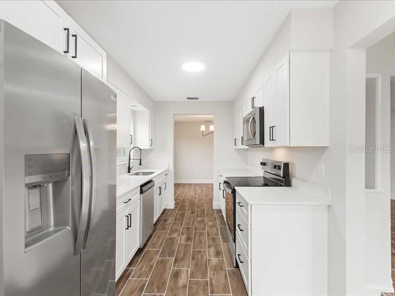 1941 Settlement Road, Unit 11 Venice, FL 34285 - Photo 15 of 39 a kitchen with stainless steel appliances granite countertop a refrigerator a stove and a sink