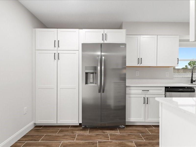 1941 Settlement Road, Unit 11 Venice, FL 34285 - Photo 16 of 39 a kitchen with a refrigerator and cabinets