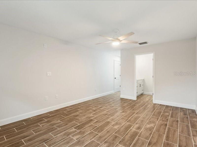 1941 Settlement Road, Unit 11 Venice, FL 34285 - Photo 18 of 39 a view of an empty room with wooden floor