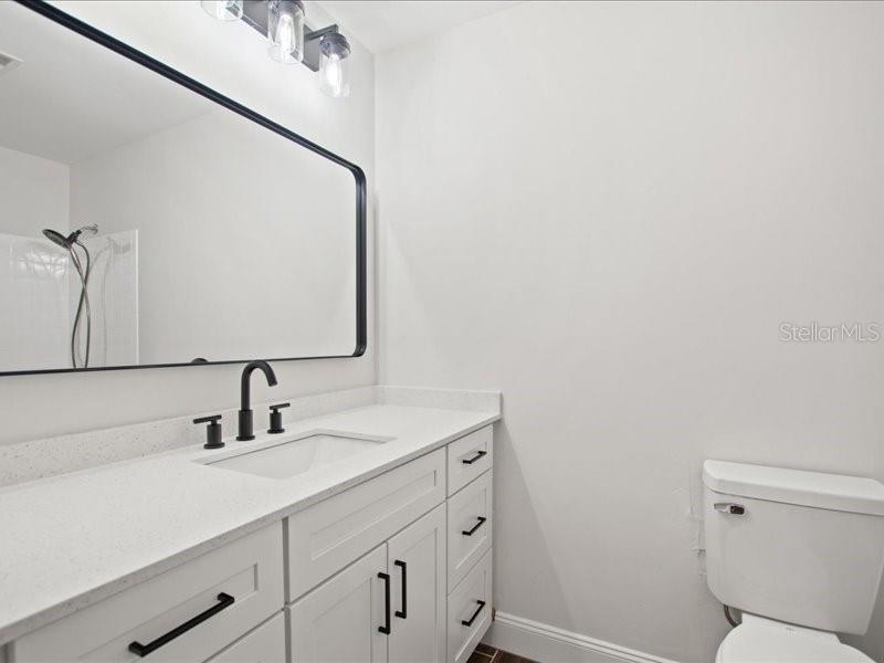 1941 Settlement Road, Unit 11 Venice, FL 34285 - Photo 20 of 39 a bathroom with a sink toilet and mirror