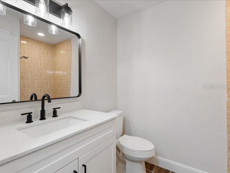 1941 Settlement Road, Unit 11 Venice, FL 34285 - Photo 21 of 39 a bathroom with a sink a toilet and mirror
