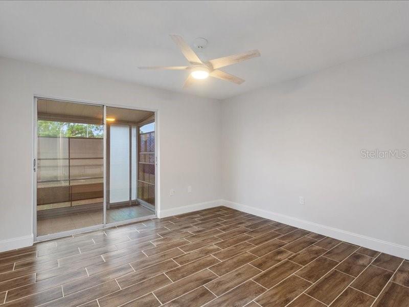 1941 Settlement Road, Unit 11 Venice, FL 34285 - Photo 23 of 39 an empty room with wooden floor and windows