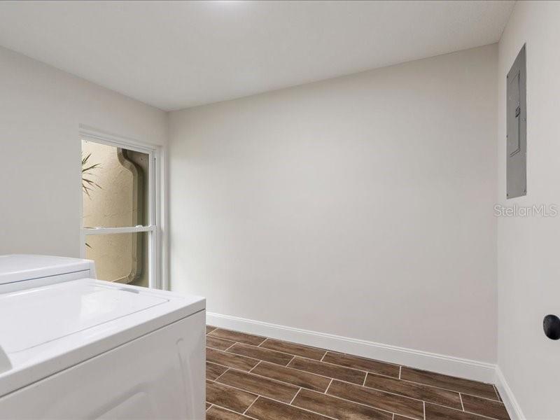 1941 Settlement Road, Unit 11 Venice, FL 34285 - Photo 28 of 39 a view of storage and utility room with washer and dryer