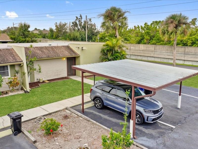 1941 Settlement Road, Unit 11 Venice, FL 34285 - Photo 33 of 39 a view of a patio with table and chairs potted plants with wooden fence