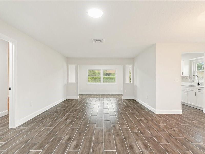 1941 Settlement Road, Unit 11 Venice, FL 34285 - Photo 4 of 39 a view of an empty room with wooden floor and a window