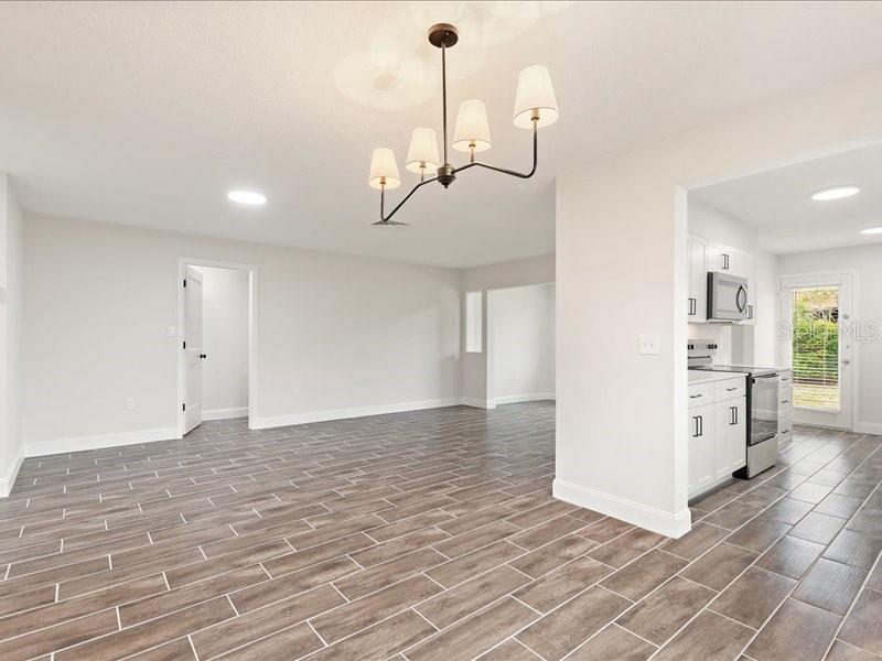 1941 Settlement Road, Unit 11 Venice, FL 34285 - Photo 7 of 39 a view of a room with wooden floor and white walls