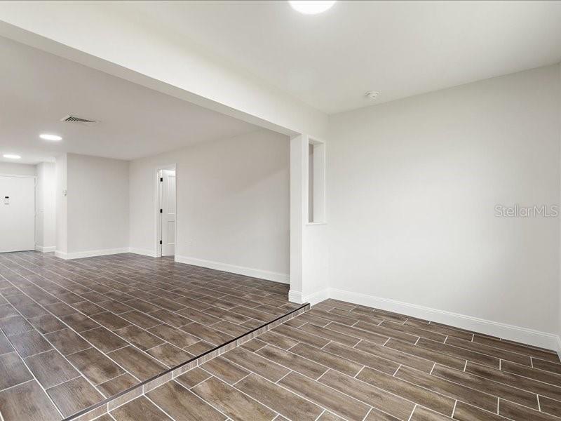1941 Settlement Road, Unit 11 Venice, FL 34285 - Photo 9 of 39 a view of a room with wooden floor and white walls