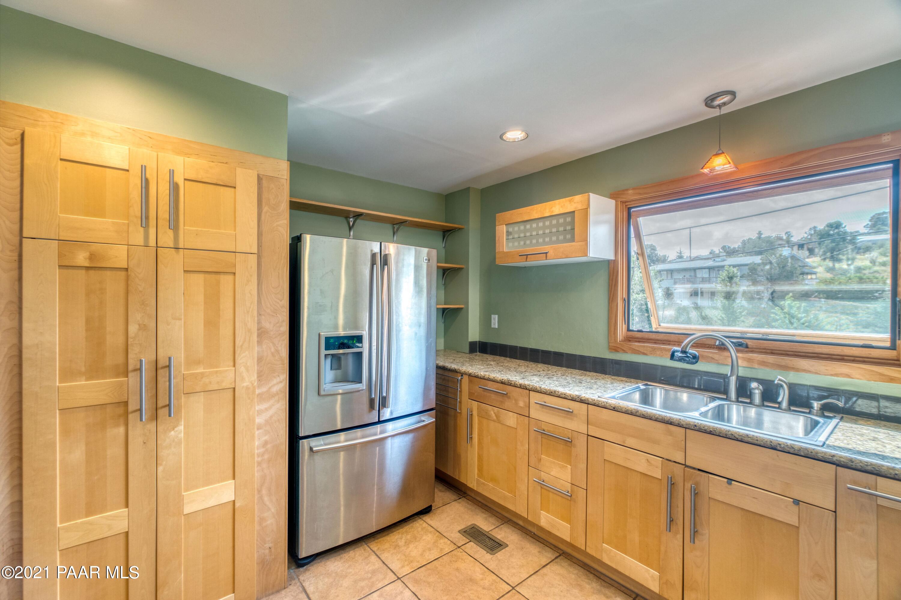 2697 Ridge Road Prescott, AZ 86301 - Photo 6 of 36 a kitchen with stainless steel appliances granite countertop a refrigerator and a sink