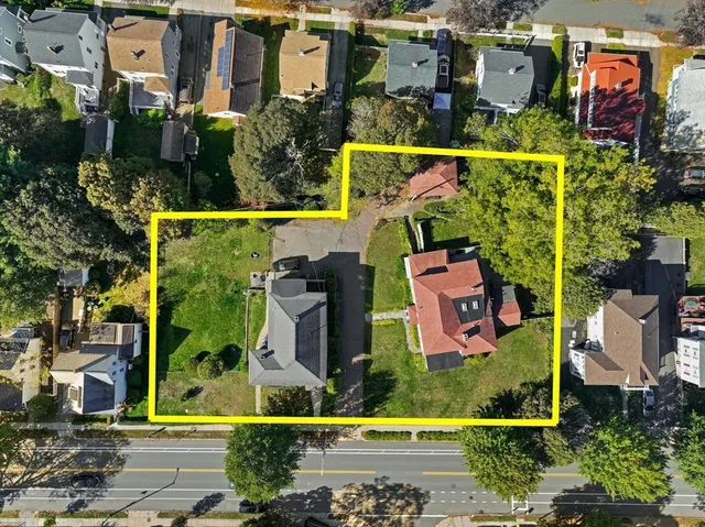 an aerial view of multiple houses with yard